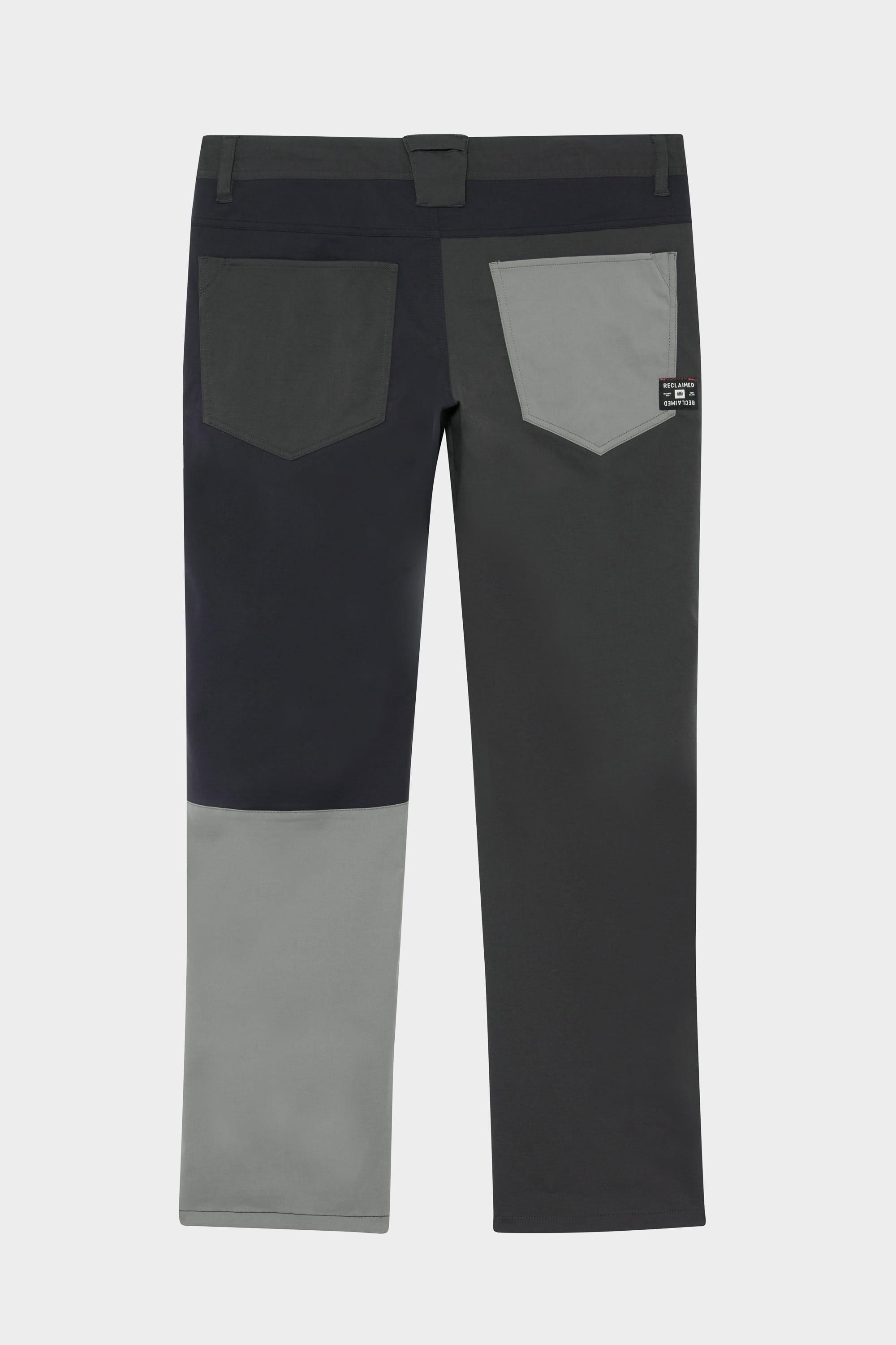 Back view of the 686 Men's Everywhere® Reclaimed Pant - Slim Fit by 686, made from deadstock fabrics in three gray tones; features belt loops and rectangular back pockets for a sustainable look.