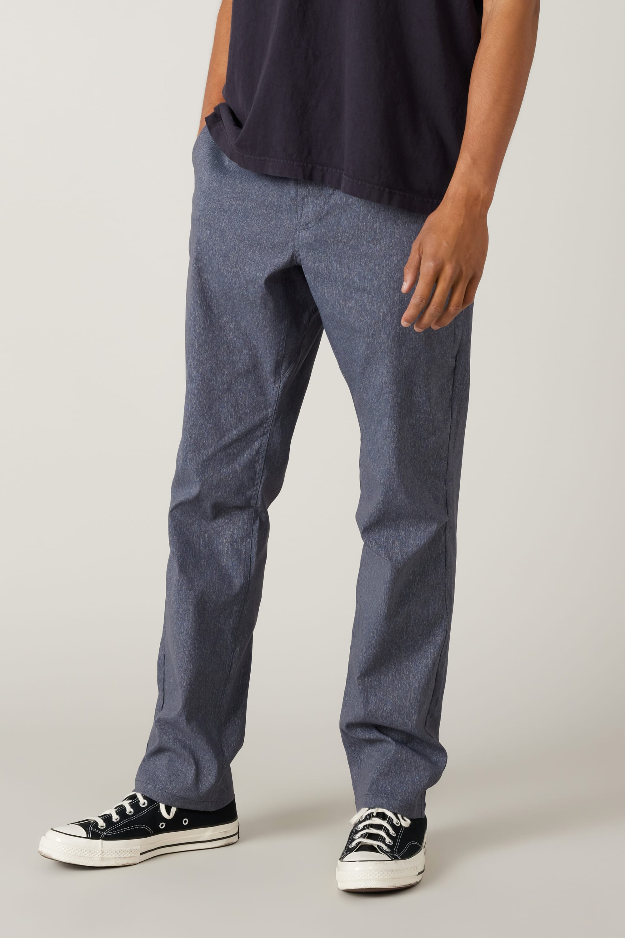 A person showcases the 686 Men's Everywhere® Pant - Relaxed Fit against a plain light background, with only the lower half visible, highlighting the pants' casual and comfortable style.