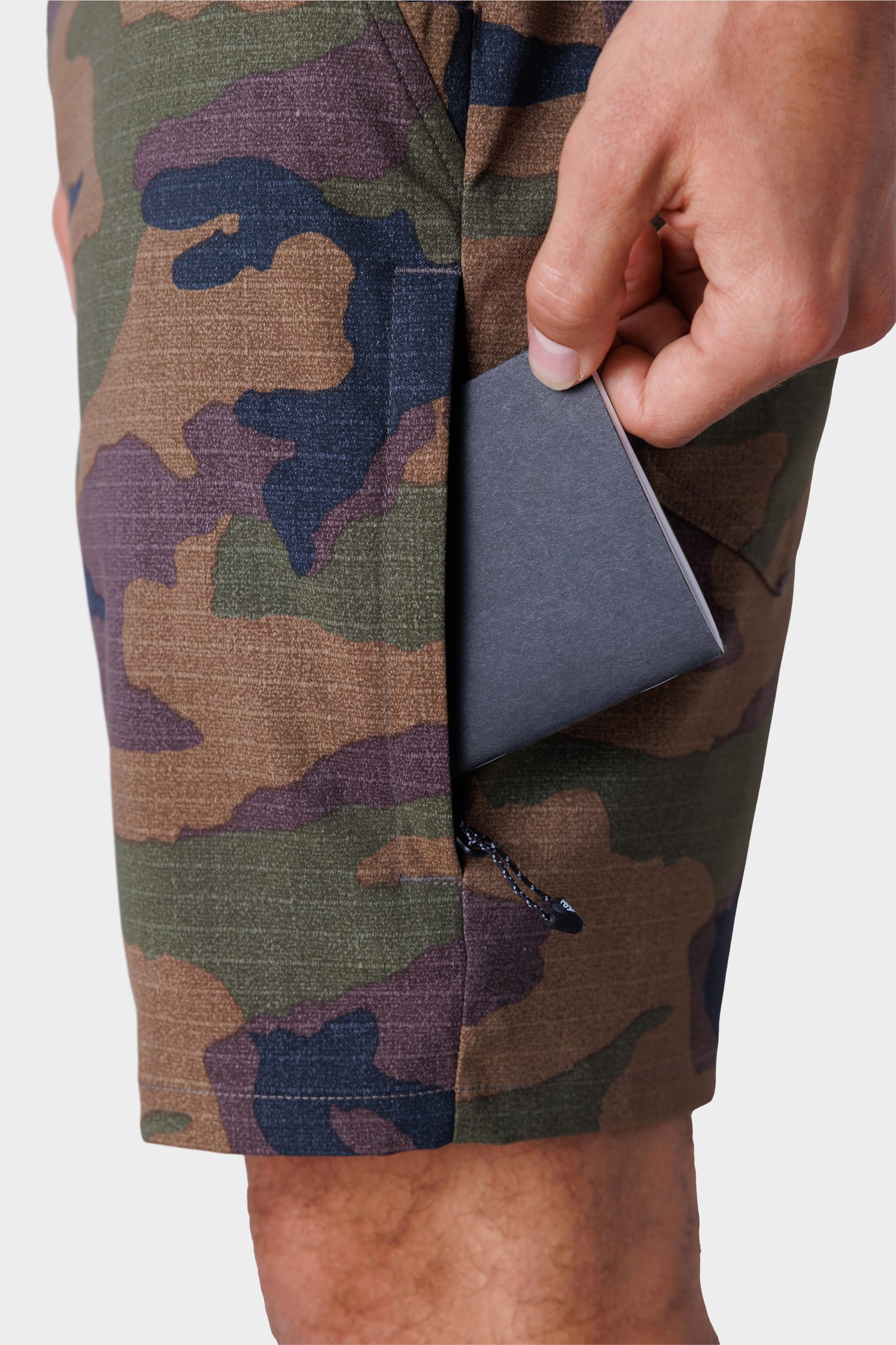 Someone slips a card into the pocket of their stain-resistant 686 Everywhere® Hybrid Short.