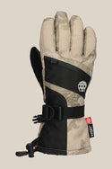 The 686 Youth Heat Glove by 686 features a tan and black geometric design, adjustable strap, wrist drawstring, and a small white paw logo. Its insulated build keeps fingers warm during cold weather activities.