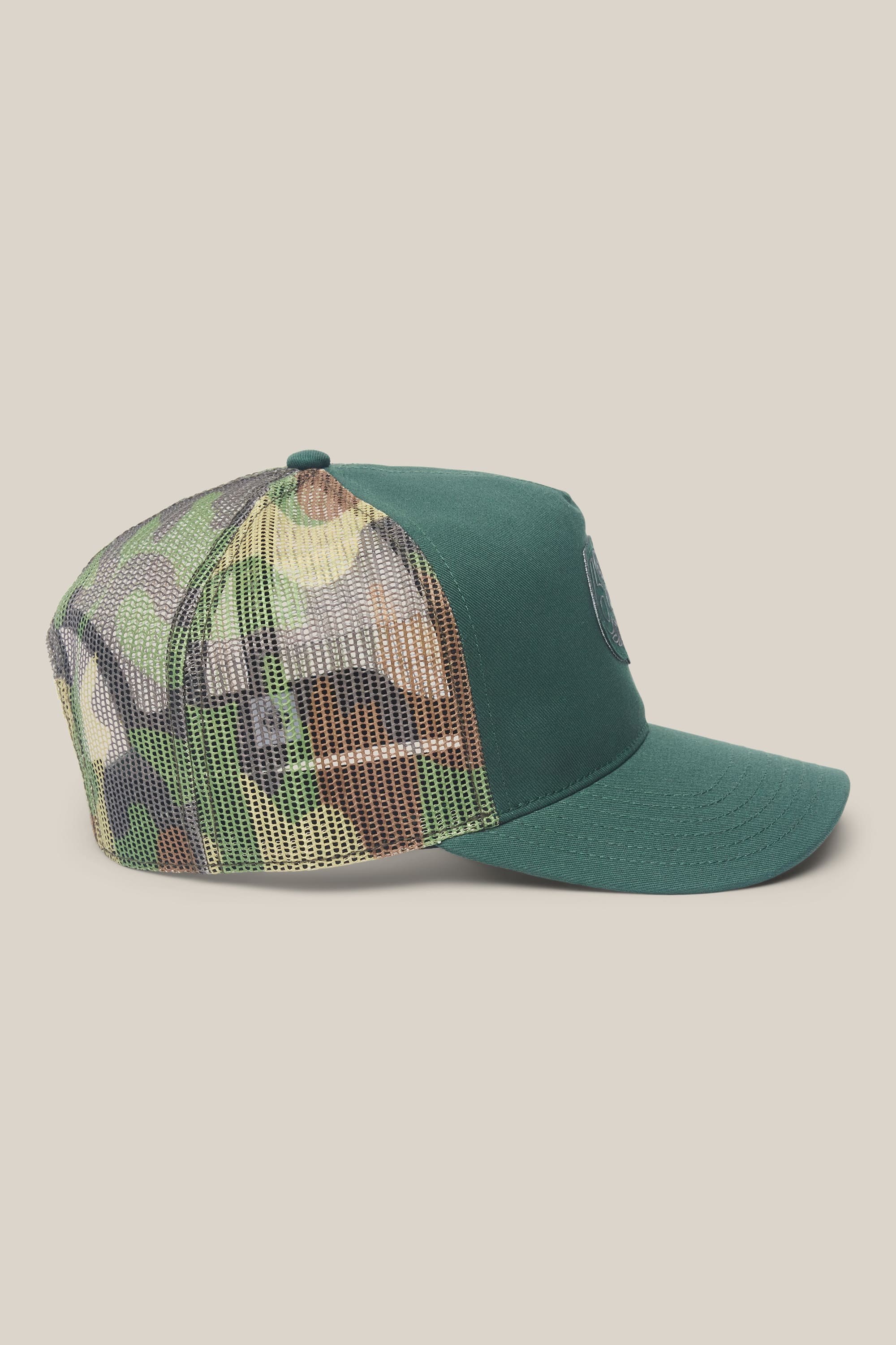 686 Mid-Pro Wreath Unstructured 5 Panel Mesh Hat by 686, featuring a green curved brim and a camouflage mesh back panel, crafted for men from durable polyester-cotton fabric. Displayed in profile view against a plain light background.