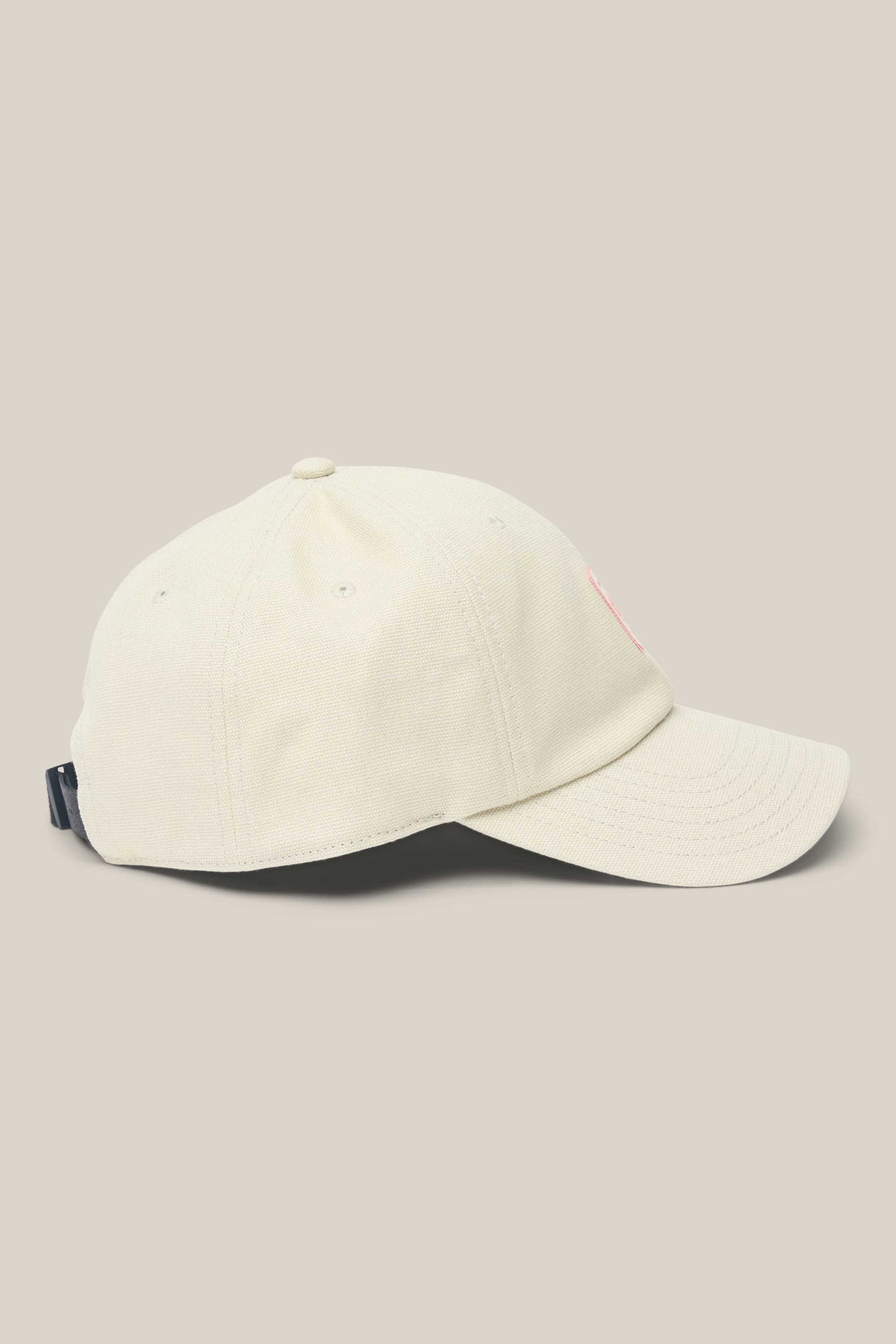 The 686 Low-Pro Unwork Unstructured 6 Panel Hat by 686 is featured in beige polyester cotton, styled as a classic baseball cap with a curved brim and adjustable back strap. Shown from the side against a plain light background, this men's hat blends timeless design with comfortable woven material.