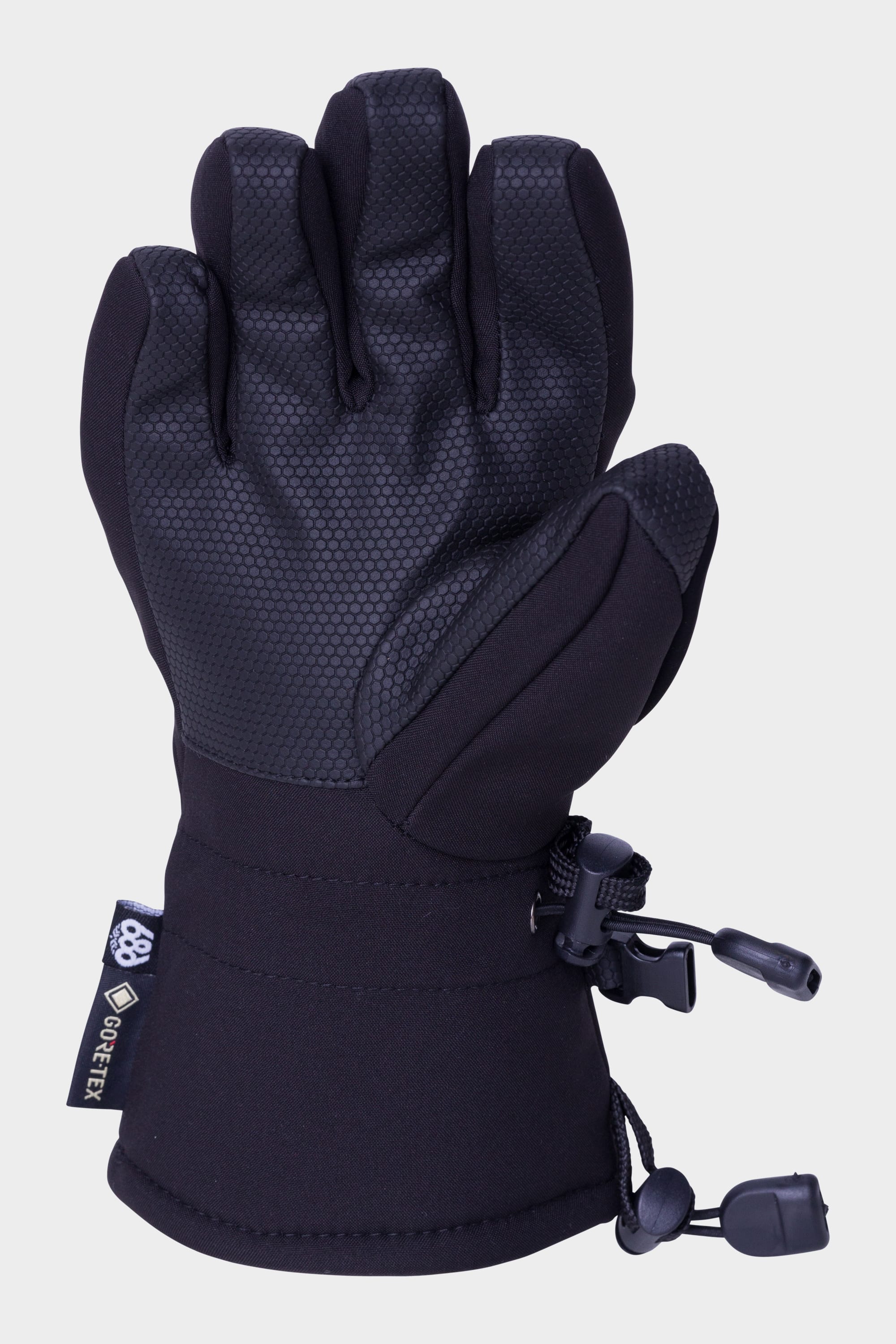 The 686 Youth GORE-TEX Linear™ Glove is a black winter glove with a textured palm, adjustable wrist strap, and cord lock. Waterproof and built for outdoors, it features a visible GORE-TEX tag. Brand: 686.