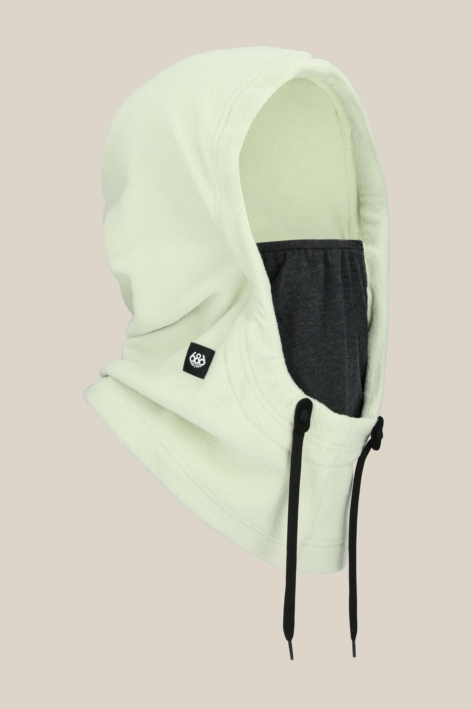 The 686 Tarmac Fleece Hood by 686 features a light green fleece, dark gray inner face covering, black drawstrings, and a small black logo tag—ideal for pairing with winter gear—displayed on a plain beige background.