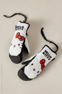 A pair of 686 Womens Revel Mitts, white and black insulated mittens by 686, featuring Hello Kitty design with red bows and HELLO KITTY text, displayed on a neutral background.