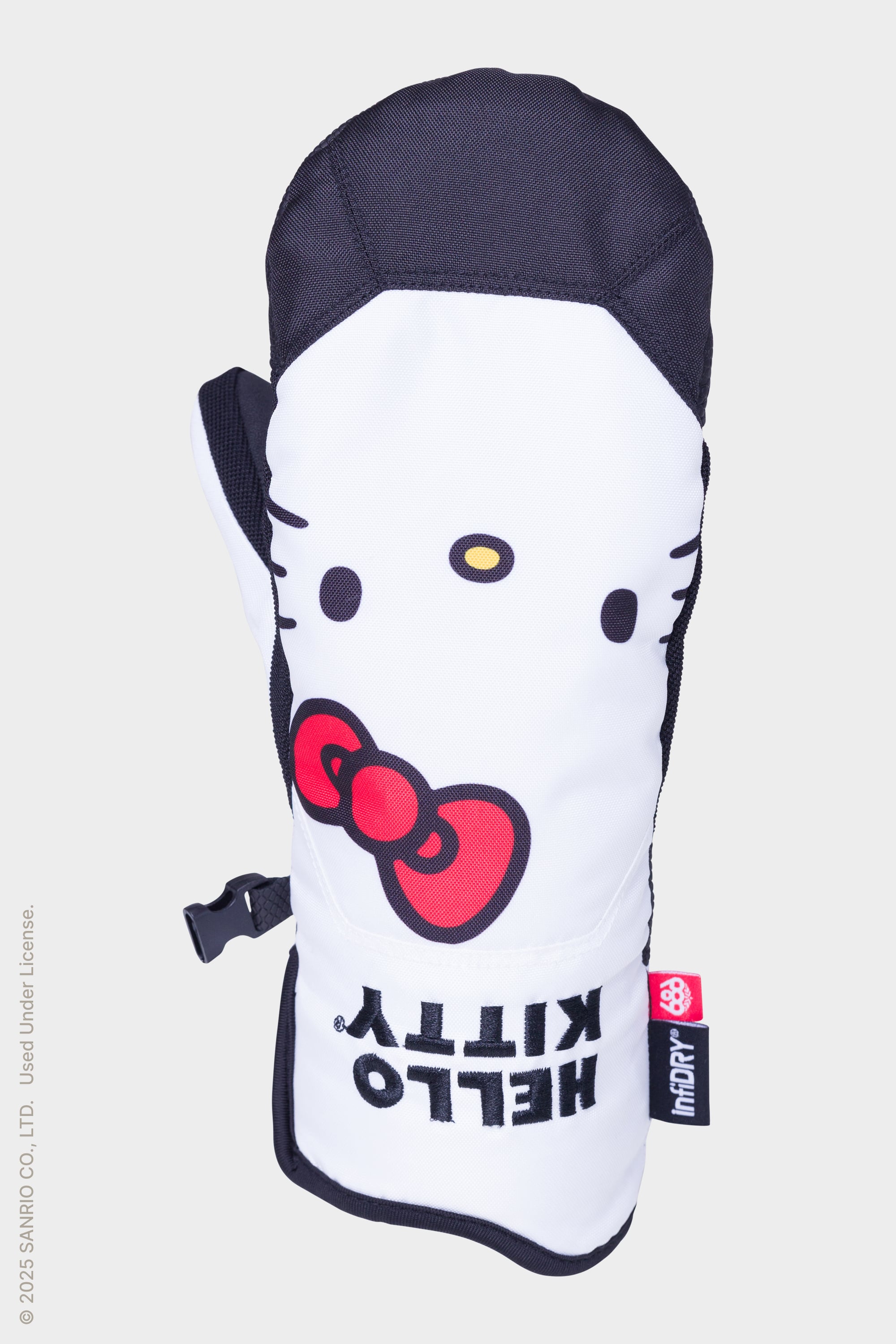 The 686 Womens Revel Mitt by 686 is a white and black insulated mitt featuring Hello Kitty’s face, red bow, bold “HELLO KITTY” text, and a small red logo tag on the bottom right side.