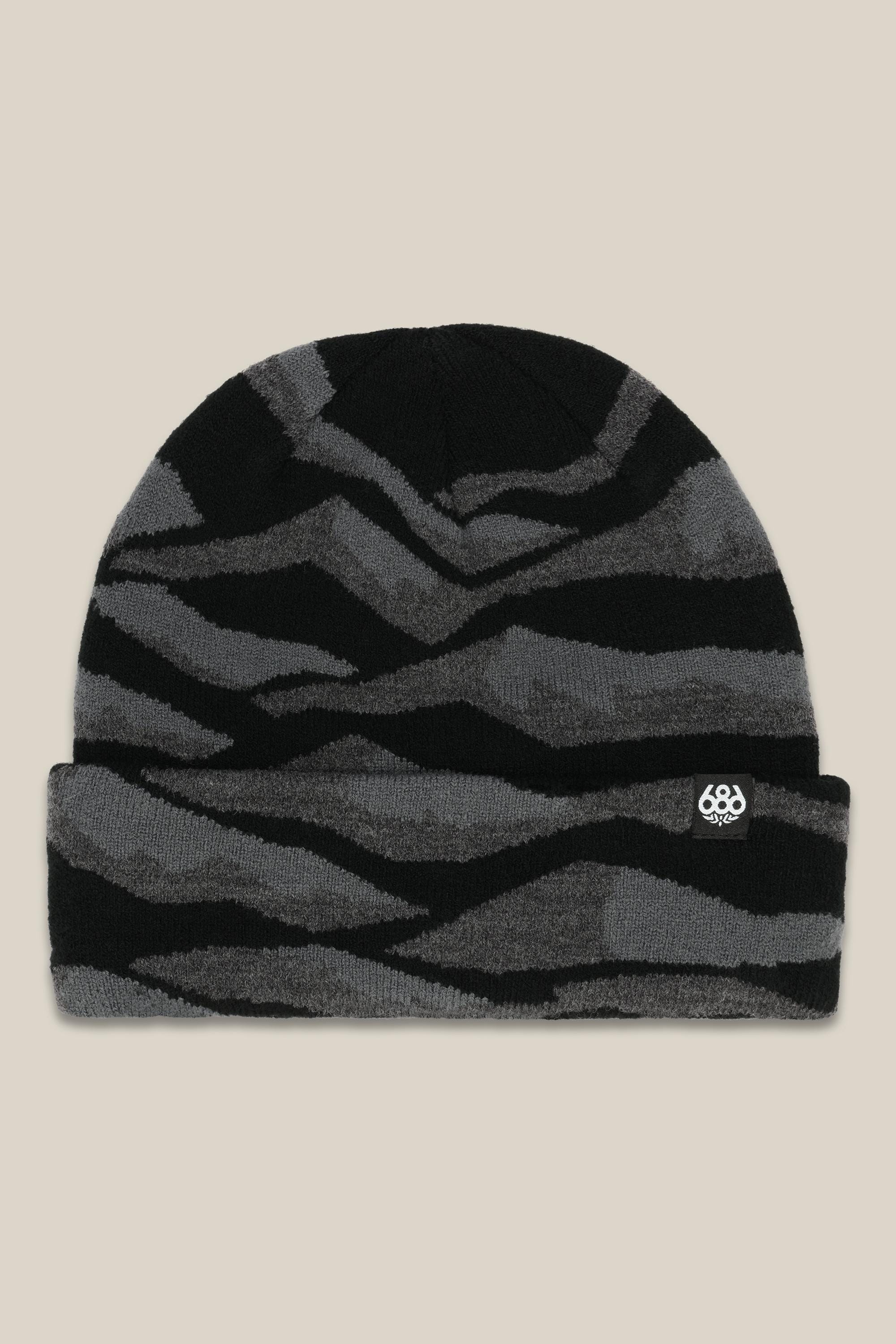 The 686 Summit Beanie by 686 features a black and dark gray wavy striped design with a small white logo patch on the folded brim, shown on a beige background—ideal for adventurous climbs or epic descents.