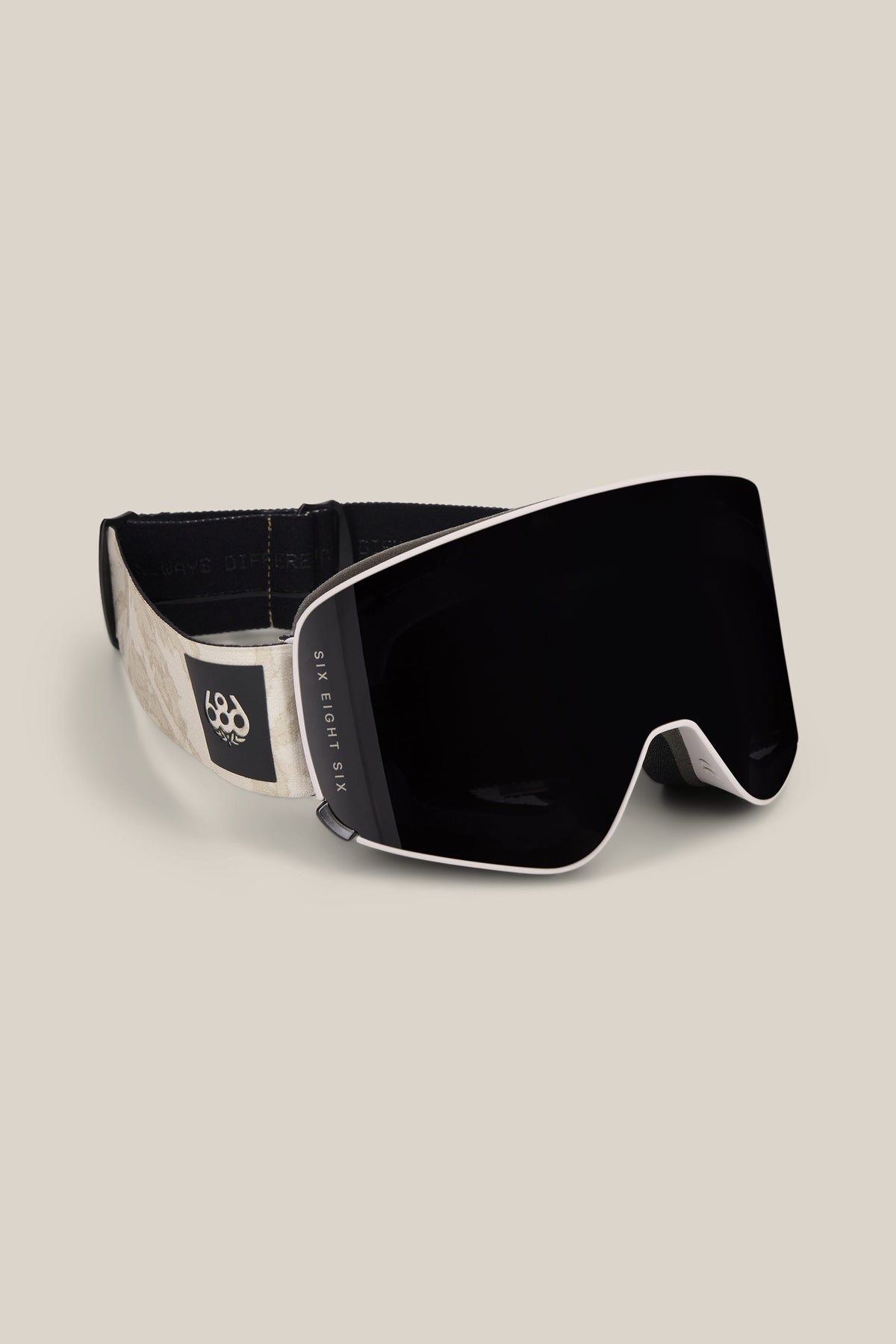 The 686 SMARTY® Magnetic Goggle by 686 features a sleek black and white design, a wide reflective lens, and an adjustable strap with a small logo on the side, showcased against a neutral background.