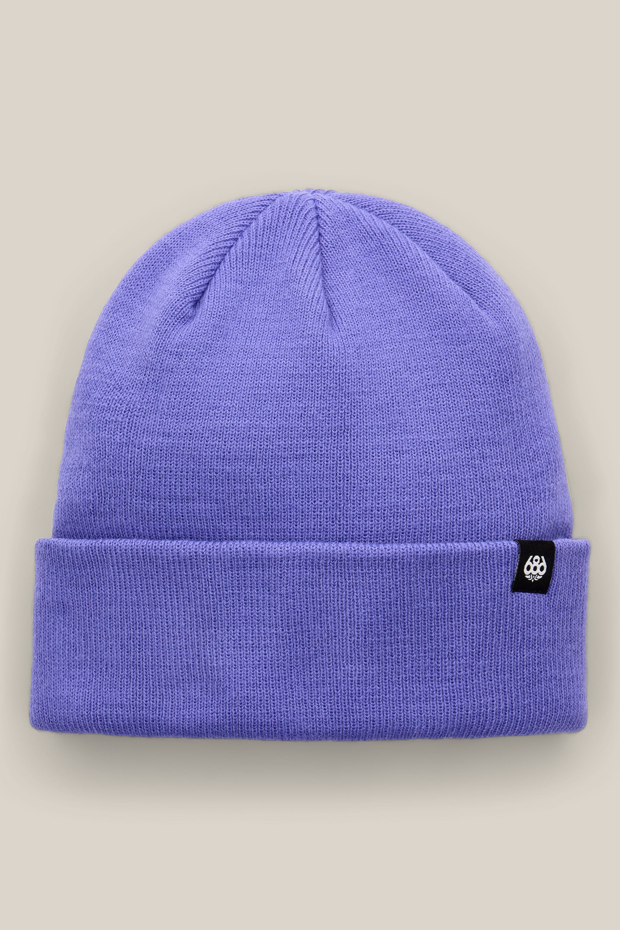 The 686 Standard Roll Up Beanie by 686 is a lavender knit hat featuring a folded brim and a small black tag with a white logo, shown against a light beige background.