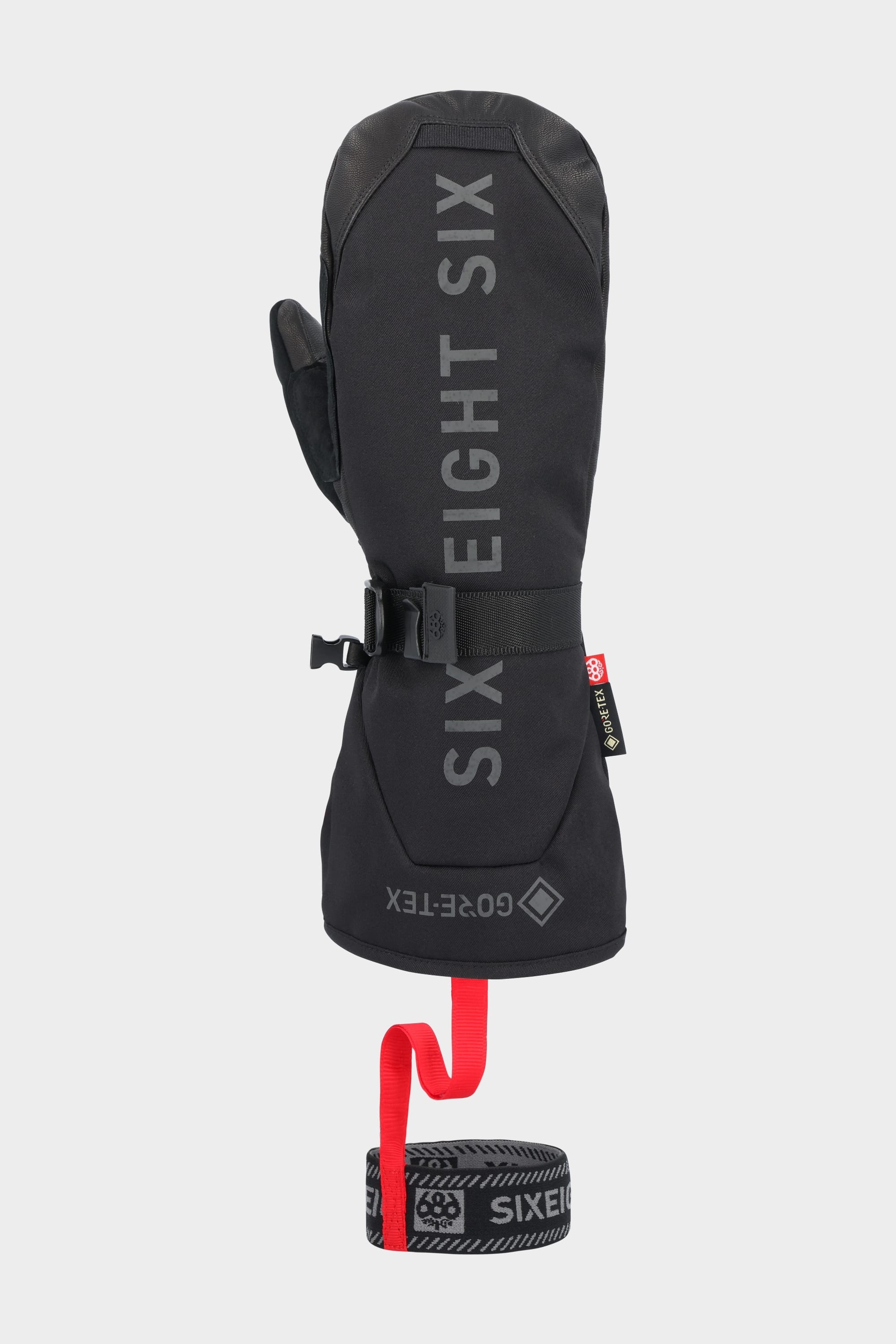 The 686 Men's GORE-TEX Leather Deep Days™ Mitt is a black leather mitt featuring GORE-TEX waterproofing, a secure wrist cinch, and an attached black-and-red leash with repeating SIX EIGHT SIX logos.