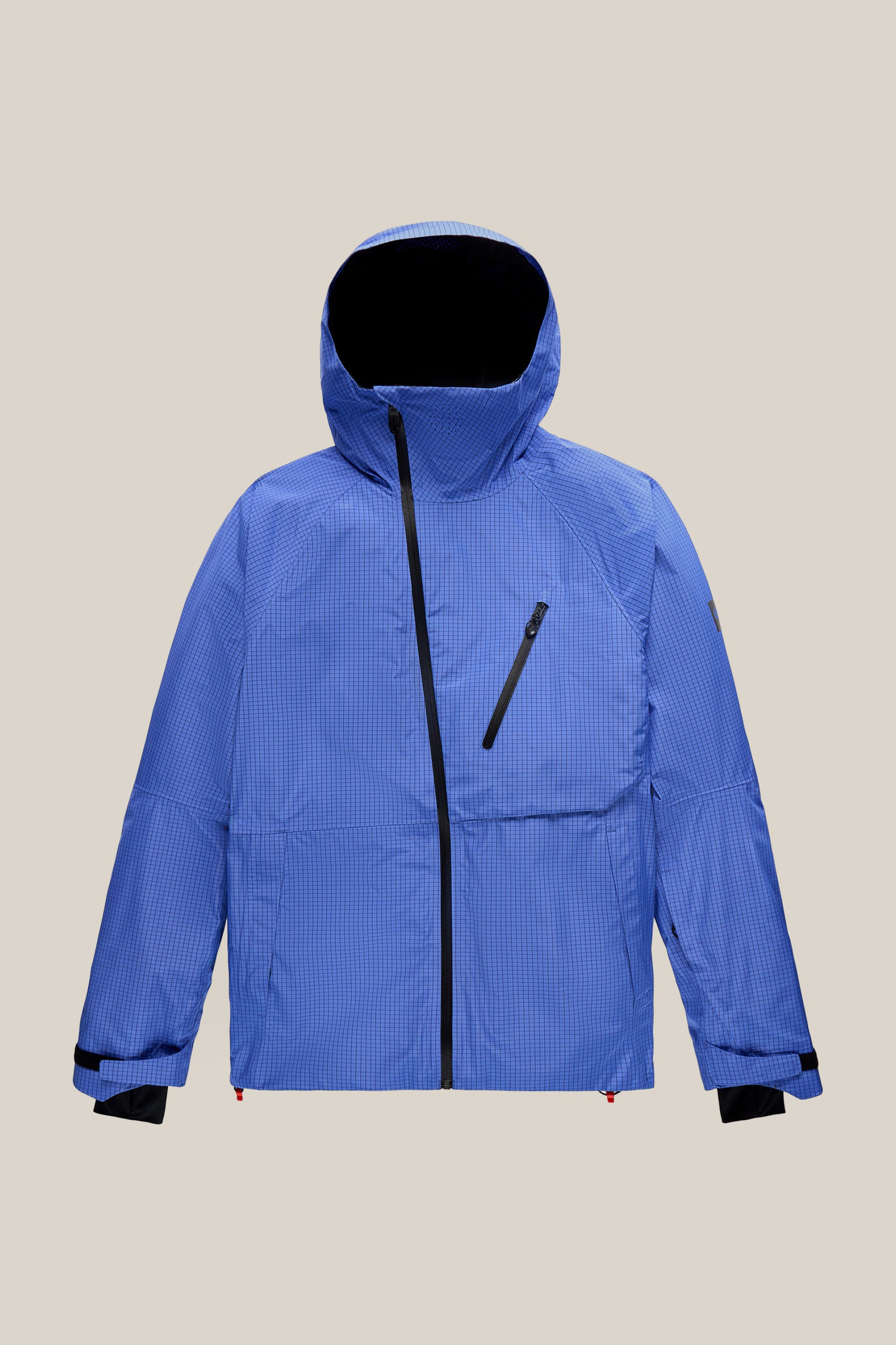The 686 Men’s Hydra™ Thermagraph® Jacket by 686 features a blue design with black zipper details, a slanted chest pocket, adjustable cuffs, and a high collar, displayed on a plain beige background.