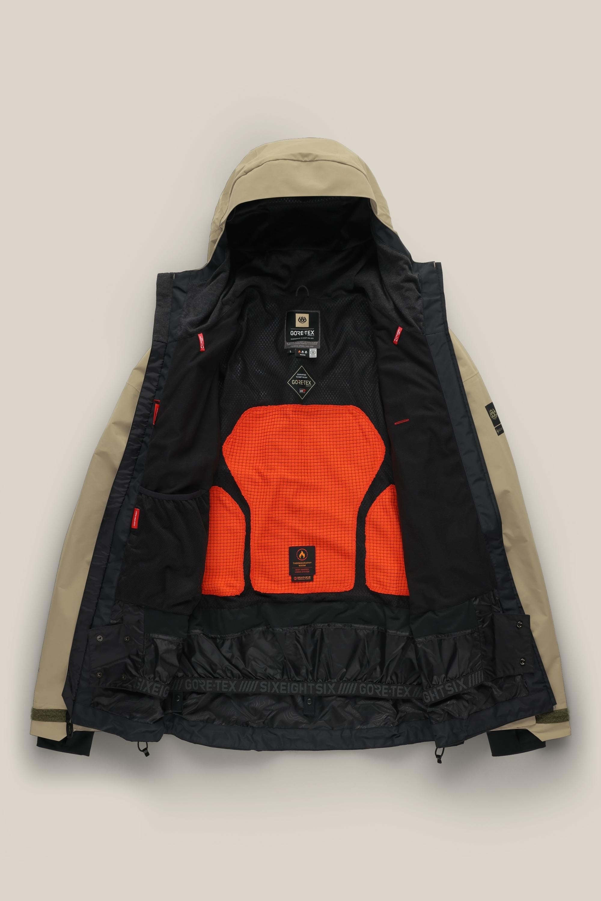 The 686 Men's GORE-TEX GT Thermagraph® Jacket in tan features a black interior with an orange mesh back panel, showcasing GORE-TEX and 686 branding. This waterproof jacket offers adjustable cuffs and inner pockets for added functionality.