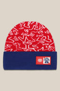 The 686 PBR Beanie by 686 is a red acrylic knit men's beanie with white abstract designs, a blue folded brim, and two patches: "686" in white and the Pabst Blue Ribbon logo.