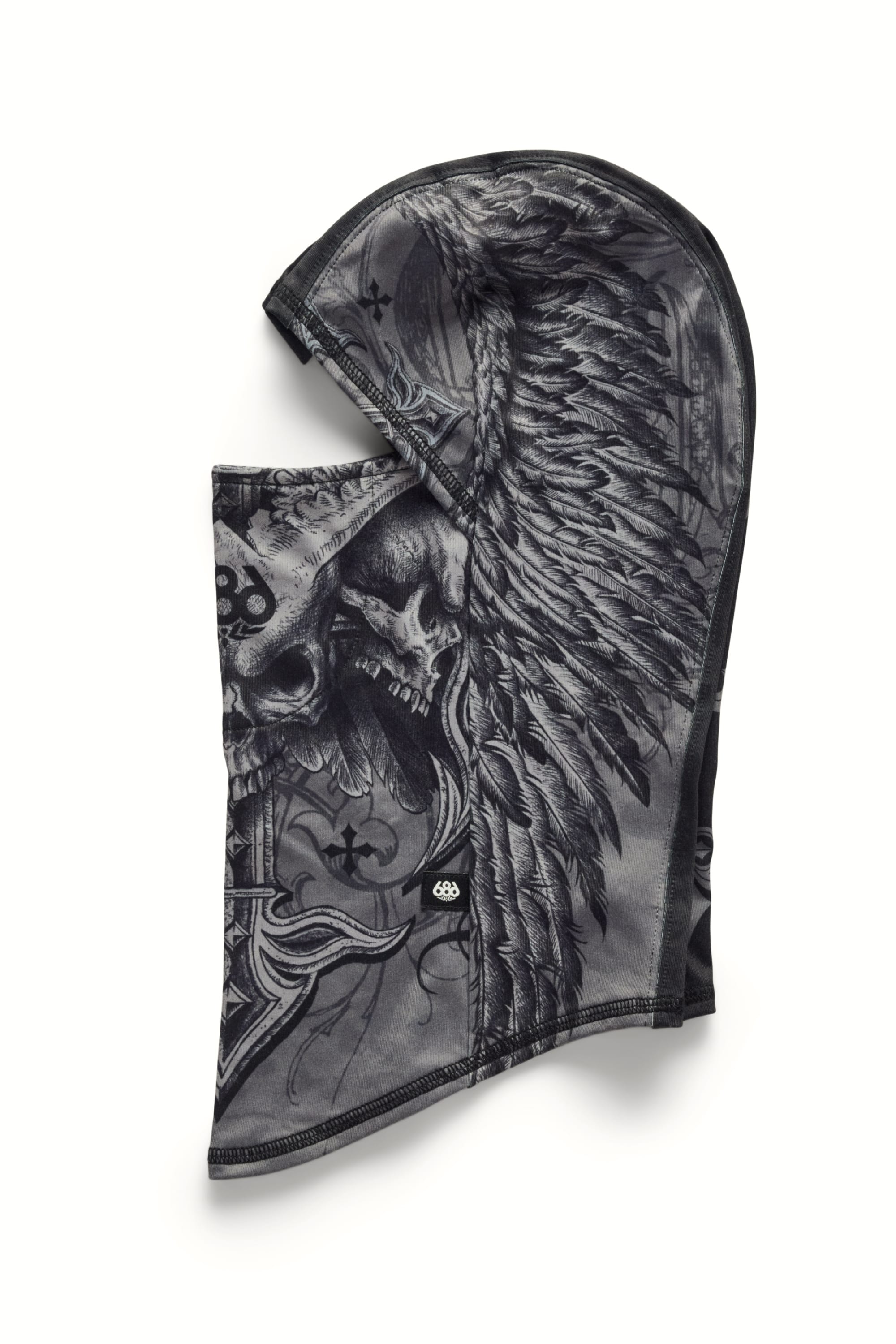 The 686 Affliction Hurra Hinged Balaclava by 686 is a black and gray polyester facemask featuring a detailed skull graphic with large feathered wings and intricate swirling side designs.