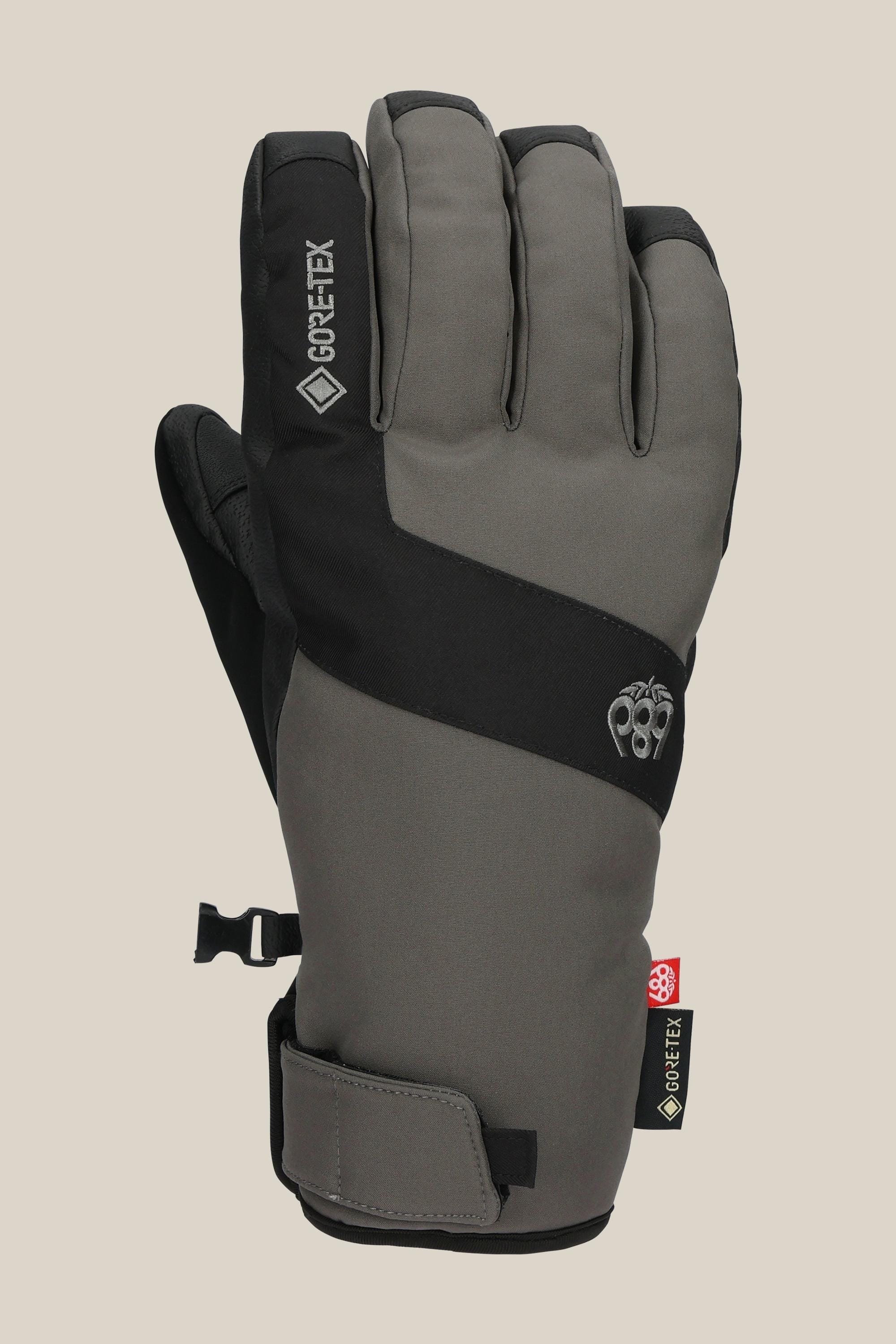 The 686 Men's GORE-TEX Linear™ Under Cuff Glove is a gray and black PU winter glove with adjustable wrist strap and small clip, ideal for cold weather activities.