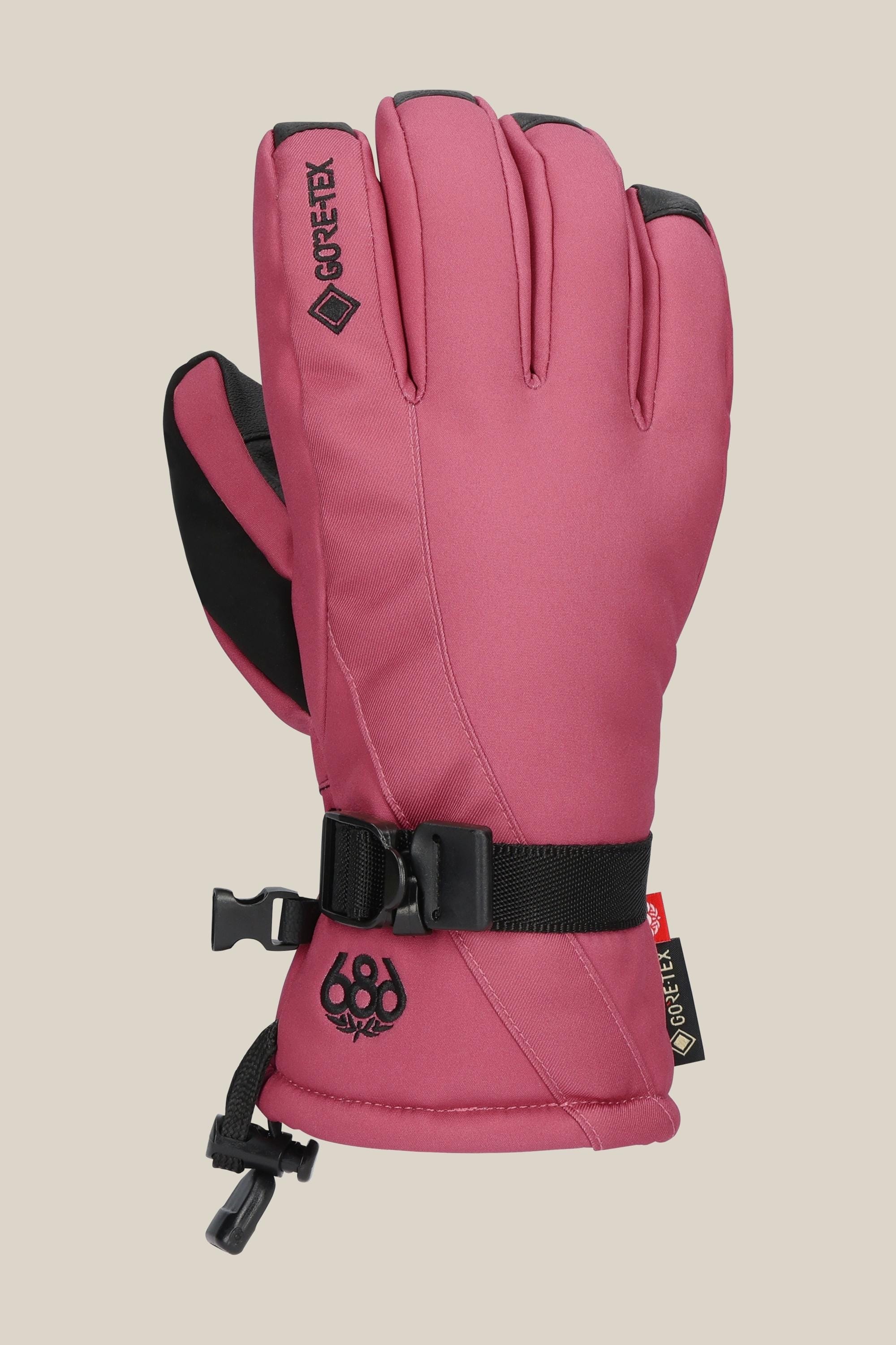 The 686 Women's GORE-TEX Linear™ Glove is a pink insulated glove with black accents, an adjustable wrist strap, small 686 logo near the cuff, reinforced fingertips, and a GORE-TEX tag for cold weather protection.