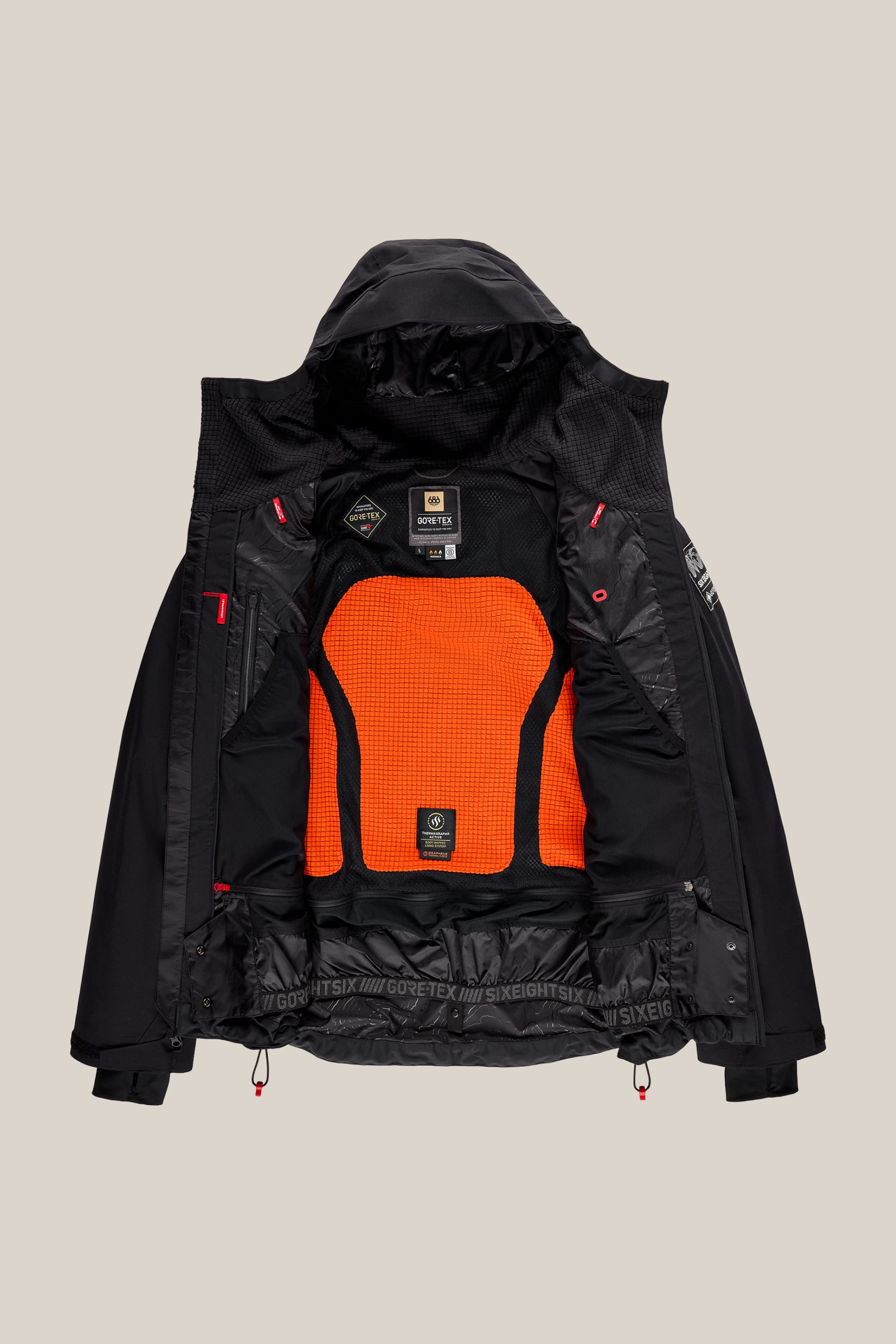 The 686 Men’s GORE-TEX® Dispatch™ Thermagraph® Jacket by 686 is shown open to reveal its interior, which features an orange mesh back panel, black lining, and several interior labels and logos—including a prominent GORE-TEX label. The hood is visible at the top, showcasing the thoughtful design of this men’s woven jacket.