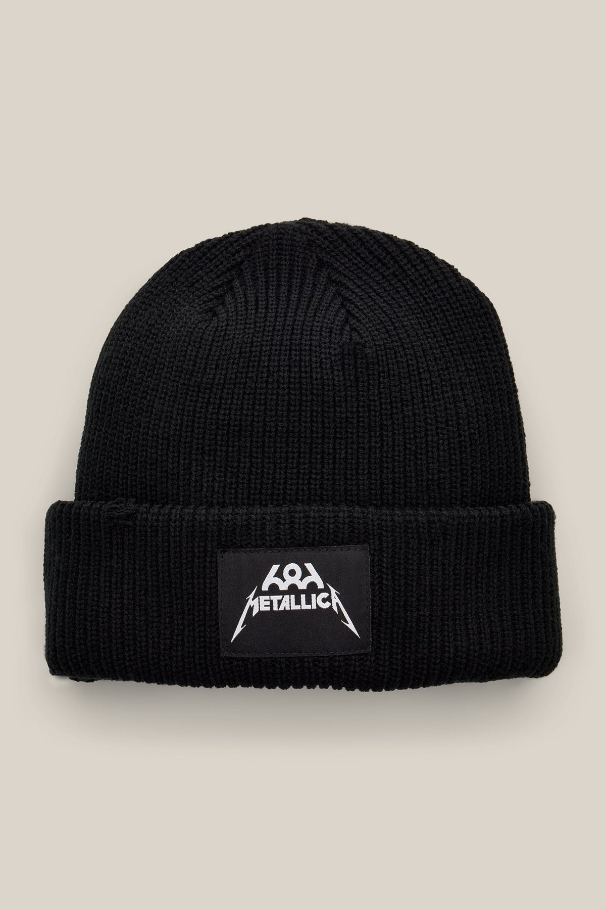 Black 686 Metallica Cuff Beanie made of ribbed knit with a rectangular patch featuring a white Metallica logo.