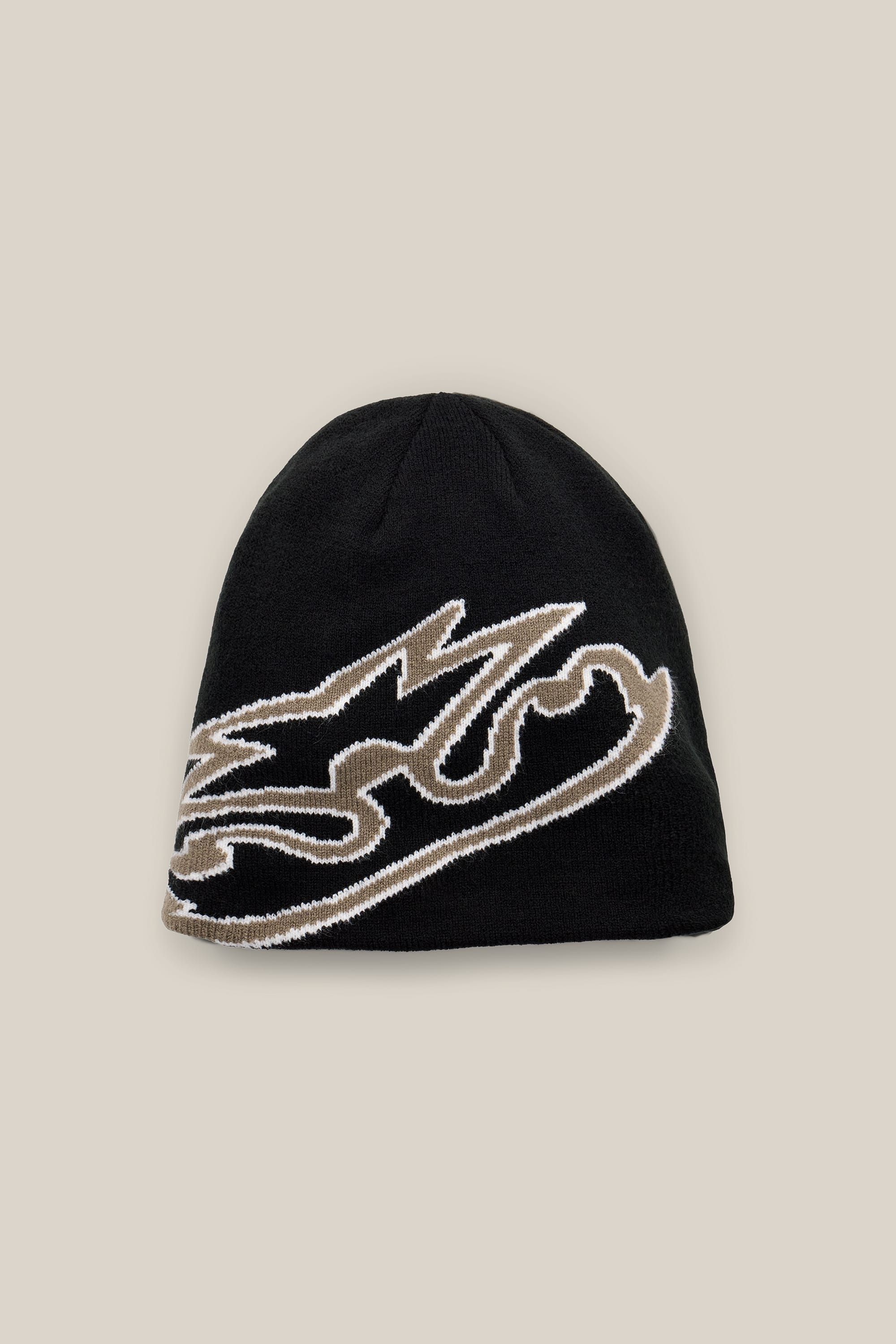The 686 Jib Skully Beanie by 686 is a black acrylic knit beanie showcasing a bold, stylized beige and white graphic design on the front, set against a light beige background.