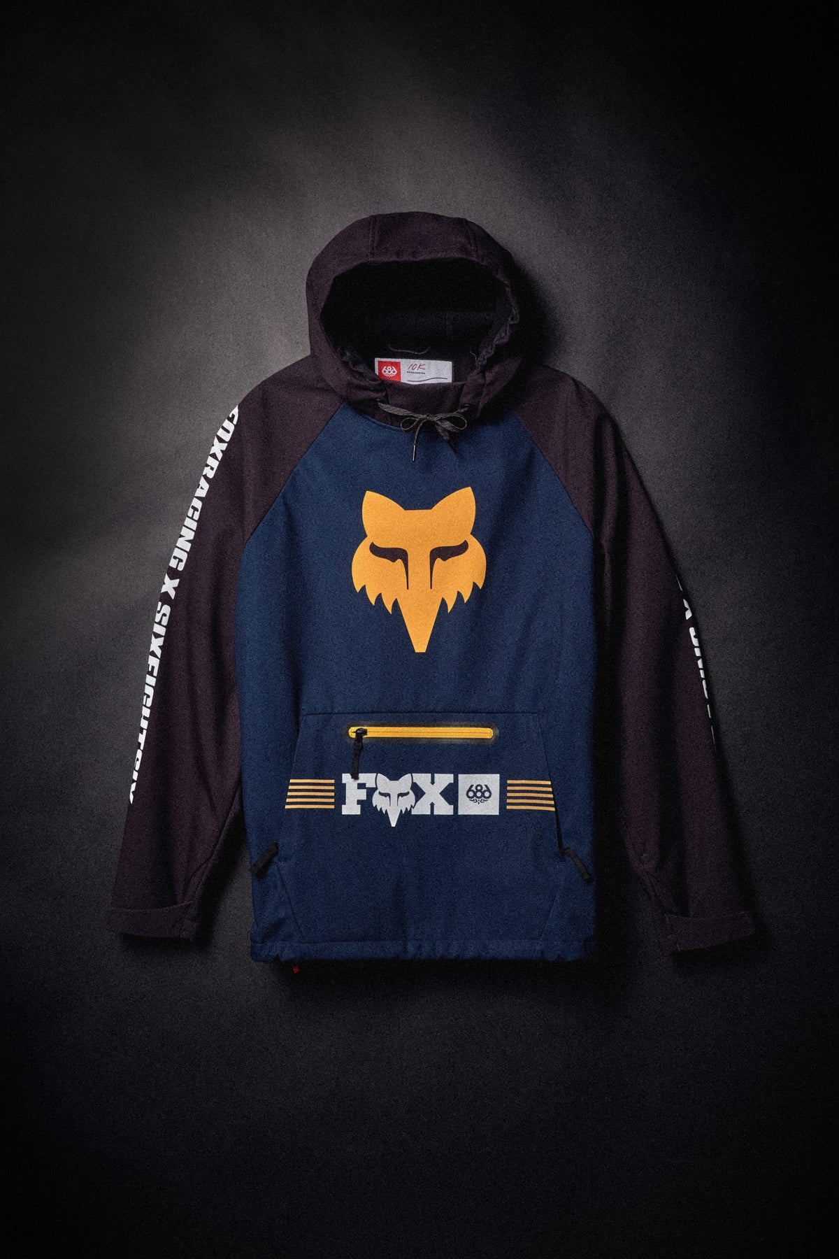 686 Men’s Fox Racing Waterproof Hoody featuring a large fox head logo on the chest and a front zippered pouch.