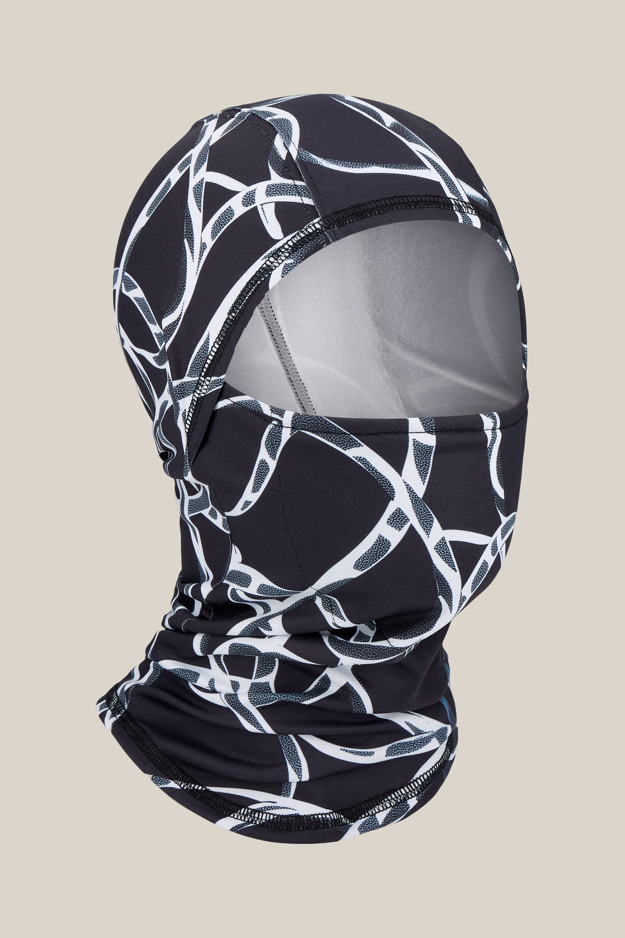 The 686 Hurra Hinged Balaclava by 686 features a striking black and white curved line pattern, shown against a neutral background. The face opening reveals an inner layer that highlights the mask’s thoughtful construction and fit. Made from soft merino wool, this unisex accessory seamlessly blends comfort with versatile style.