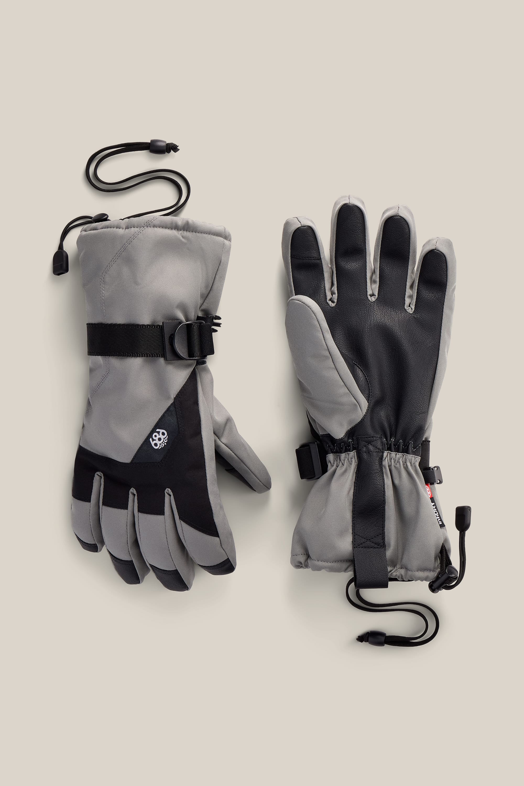 A pair of 686 Men’s Sightline™ Gloves in gray and black, featuring adjustable wrist straps and attached leashes, crafted in a durable poly glove design, displayed on a neutral background.