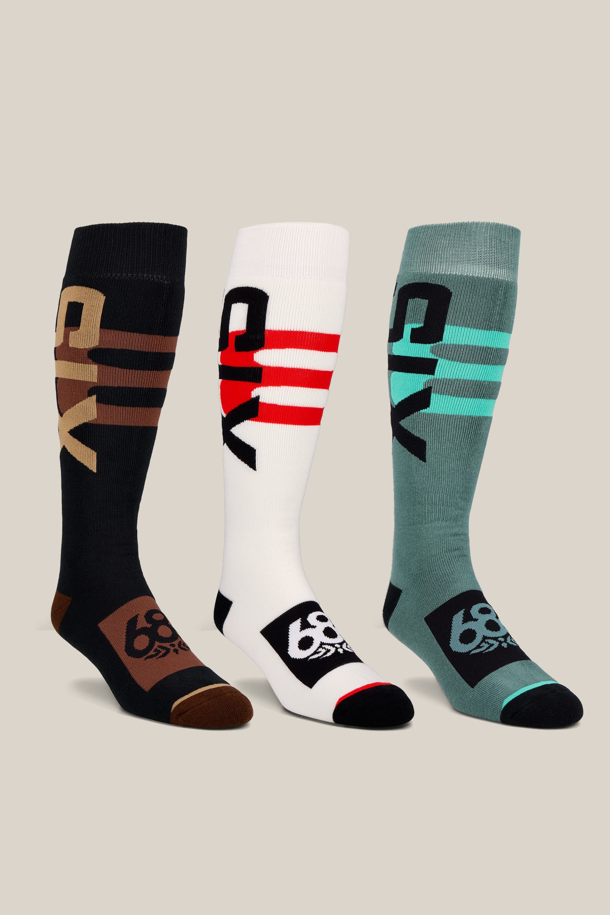 The 686 Men’s Swiss Socks 3-Pack includes knee-high performance socks in black, white, and teal—each designed with bold stripes, “DIY” lettering on the sides, and “66” numbers on the toes. These men’s acrylic socks from 686 feature contrasting toes, heels, and bands for a distinctive athletic style.