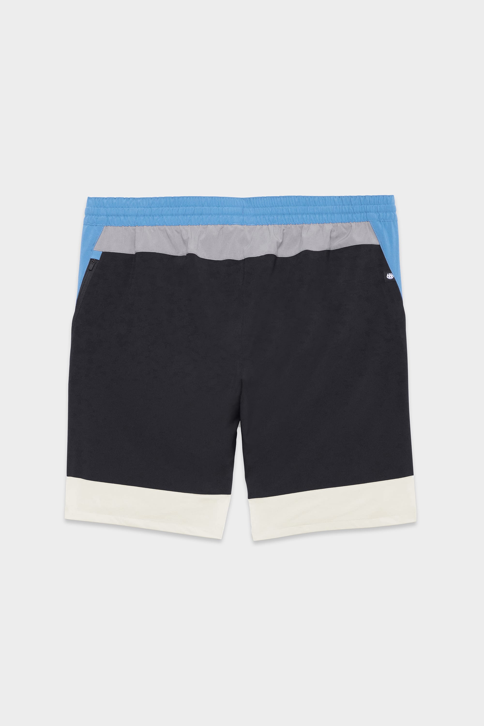 The 686 Mens ATP Stretch Performance Short features color-blocked panels—blue on top, gray below, black in the middle, and white at the bottom—with an elastic waistband and side pockets for comfort and style.